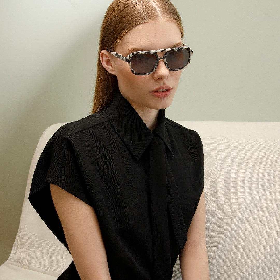 a man wearing sunglasses and a black shirt 