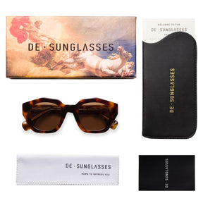 a magazine with a cell phone and sunglasses 